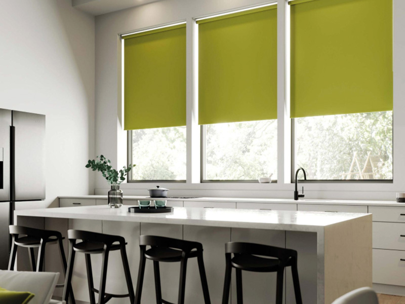 green roller blinds on 3 windows in kitchen with white kitchen island